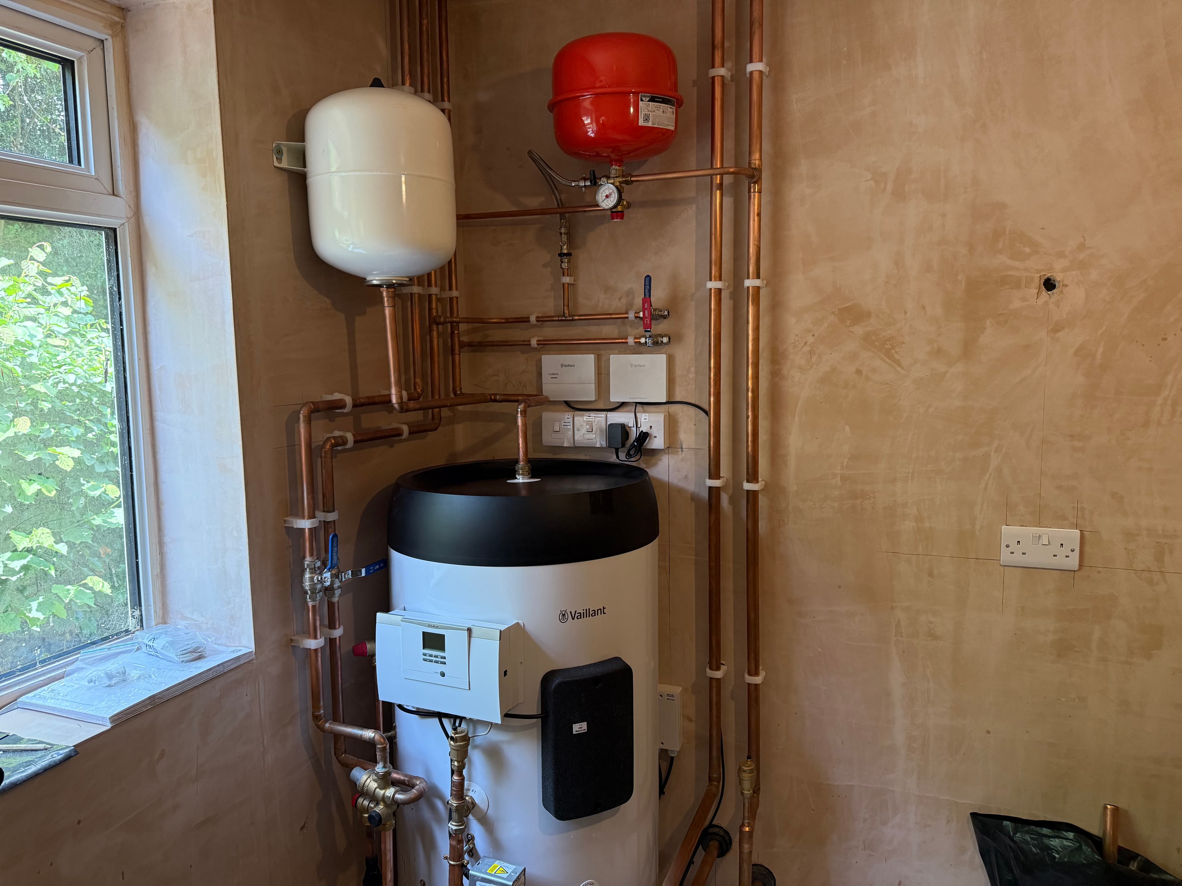 Neat copper pipework and cylinder installed by PG Renewables
